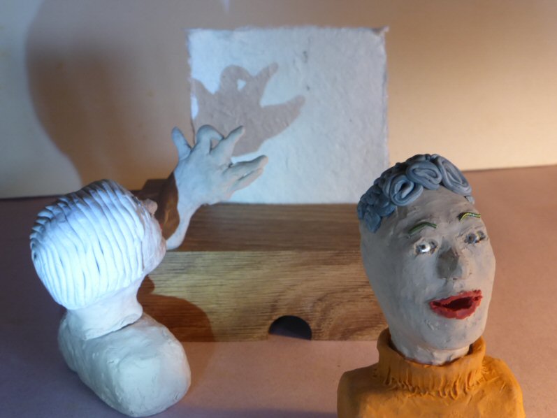 2 plasticine heads and shadow play creature